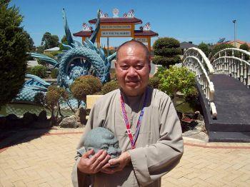 PERSECUTED: A Buddhist monk holds a desecrated statute at his temple in Marangaroo, Western Australia, January, 2009. He believes Hanoi was behind the attack. (Scott Johnson)